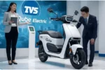 India में electric two-wheelers का market पिछले कुछ सालों में तेजी से बदला है। Petrol prices, daily running cost और environmental concerns ने लोगों को EV की तरफ seriously सोचने पर मजबूर किया है। इसी changing mindset के बीच TVS ने अपने popular electric scooter iQube को लगातार update किया है। अब 2026 में TVS iQube Electric Scooter एक नए avatar में सामने आ रहा है, जहां focus सिर्फ electric होना नहीं, बल्कि practical, reliable और affordable smart EV बनना है। TVS iQube पहले से ही family buyers और daily commuters के बीच एक trusted name रहा है। Company ने शुरू से aggressive claims करने के बजाय real-world usability पर ध्यान दिया। 2026 version में भी यही approach दिखती है, लेकिन इस बार better range, refined performance और upgraded tech के साथ। Design और Overall Look TVS iQube 2026 का design बहुत ज्यादा flashy नहीं है, लेकिन यही इसकी strength भी है। Scooter का look clean, mature और urban users को ध्यान में रखकर बनाया गया है। Front apron में LED headlamp setup मिलता है जो night riding में clear visibility देता है। Indicators और tail lamp भी LED हैं, जिससे scooter modern feel देता है। Body panels tight fit finish के साथ आते हैं और overall build quality TVS standard के हिसाब से solid लगती है। Seat height comfortable है, जिससे short aur tall दोनों riders आसानी से handle कर सकते हैं। Underseat storage daily use के लिए decent है, जहां helmet या small luggage रखा जा सकता है। Battery, Range और Performance TVS iQube Electric Scooter 2026 में improved battery pack देखने को मिलता है। Company ने battery efficiency पर काम किया है, जिससे real-world range पहले से better हो गई है। Expected range around 120 km के करीब बताई जा रही है, जो city commuting के लिए काफी practical है। Motor smooth power delivery देता है, जिससे traffic में scooter चलाना आसान हो जाता है। Pickup linear है, कोई sudden jerk feel नहीं होता। Top speed city use के हिसाब से balanced रखी गई है, ताकि safety और battery efficiency दोनों maintain रहें। Charging की बात करें तो home charging support standard है। Normal charger से battery overnight या कुछ घंटों में comfortably charge हो जाती है। Fast charging option भी selected variants में मिलने की उम्मीद है, जो busy users के लिए helpful साबित हो सकता है। Smart Features और Technology TVS iQube 2026 का एक बड़ा highlight इसका tech package है। Scooter में full digital TFT display मिलता है जो speed, range, battery percentage और ride stats clear तरीके से दिखाता है। Display brightness outdoor conditions में भी readable रहती है। Connected features भी काफी practical हैं। Smartphone app के through navigation assist, call alerts, geo-fencing और vehicle tracking जैसे options मिलते हैं। ये features सिर्फ show-off नहीं हैं, बल्कि daily riding experience को genuinely convenient बनाते हैं। Reverse assist feature tight parking spaces में काफी useful साबित होता है। इसके अलावा multiple riding modes भी दिए गए हैं, जिससे rider performance और efficiency के बीच choose कर सकता है। Ride Comfort और Handling Indian road conditions को ध्यान में रखते हुए TVS ने suspension setup balanced रखा है। Front telescopic forks और rear shock absorbers uneven roads और speed breakers को अच्छे से handle करते हैं। Ride quality smooth रहती है, खासकर city speeds पर। Braking system भी confidence inspire करता है। Front disc brake और rear drum/disc option के साथ CBS safety standard मिलता है। Electric scooter होने के बावजूद weight distribution अच्छा है, जिससे cornering और U-turns easy feel होते हैं। Price और Value for Money TVS iQube Electric Scooter 2026 की सबसे बड़ी strength इसकी pricing strategy मानी जा रही है। Company इसे competitive price point पर launch करने की तैयारी में है, ताकि middle-class buyers के लिए EV adoption आसान हो सके। Government subsidies और low running cost इसे long term में petrol scooters से ज्यादा economical बना देते हैं। Maintenance cost भी comparatively low है, क्योंकि electric drivetrain में moving parts कम होते हैं। TVS ka wide service network bhi buyers ke confidence ko aur strong karta hai. Conclusion TVS iQube Electric Scooter 2026 उन लोगों के लिए एक strong option बनकर सामने आता है जो ek smart, reliable aur practical electric scooter चाहते हैं। Better range, improved tech features aur affordable pricing का combination इसे daily city commute के लिए ideal बनाता है। Ye scooter flashy promises से ज्यादा real-life usability पर focus करता है, जो Indian buyers के लिए सबसे important factor है। Overall, TVS iQube 2026 electric mobility की तरफ ek sensible aur balanced step माना जा सकता है।
